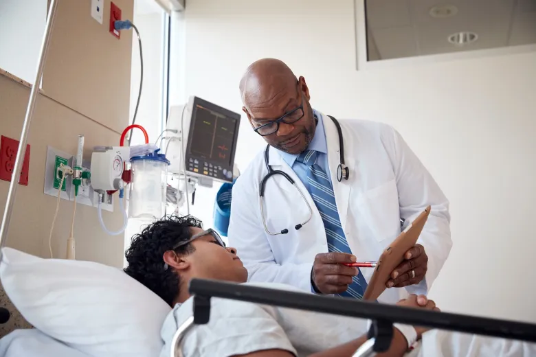 doctor talking to hospital patient