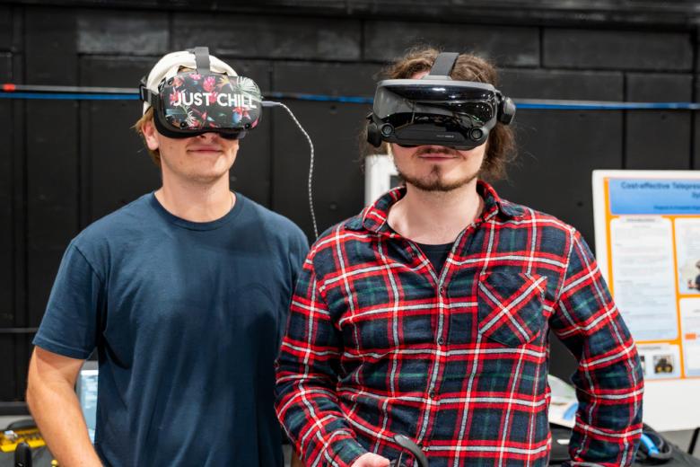 Dylan O'Brien and Owen Terry wearing VR headsets at the Computer Engineering capstone