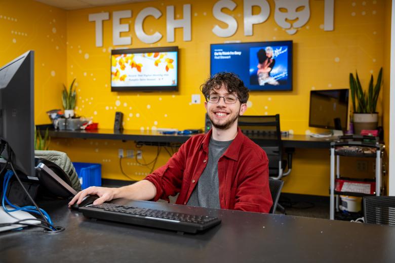 Student worker greets customers at Tech Spot