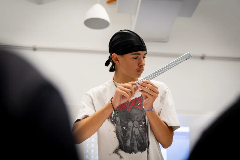 Student holding a robotics part 