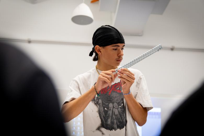 Student holding a robotics part 