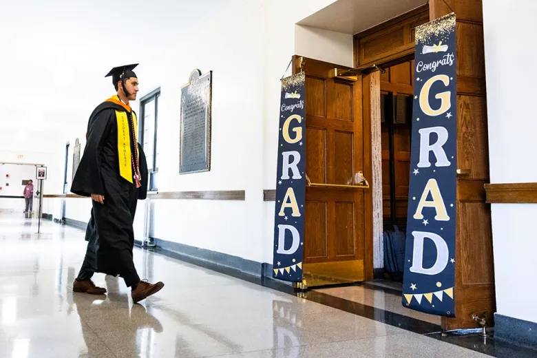 Student looking at grad sign