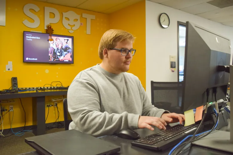 Person behind a desk using a computer