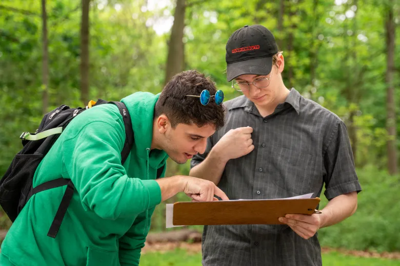 Two students looking at a clipboard