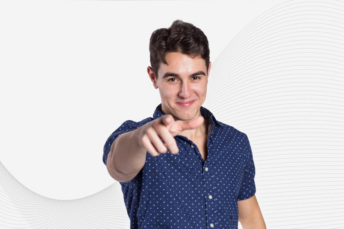 A male student points at the camera.