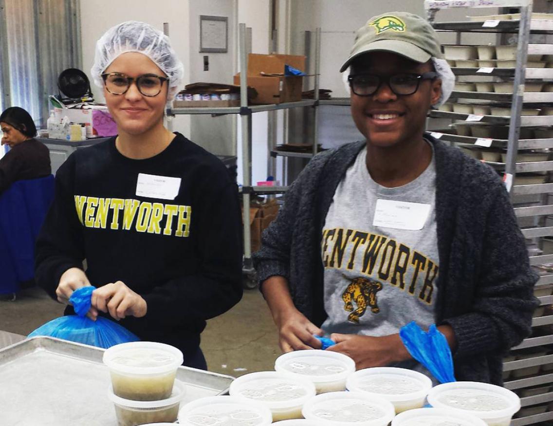 Two alternative spring break students volunteering at a food bank.