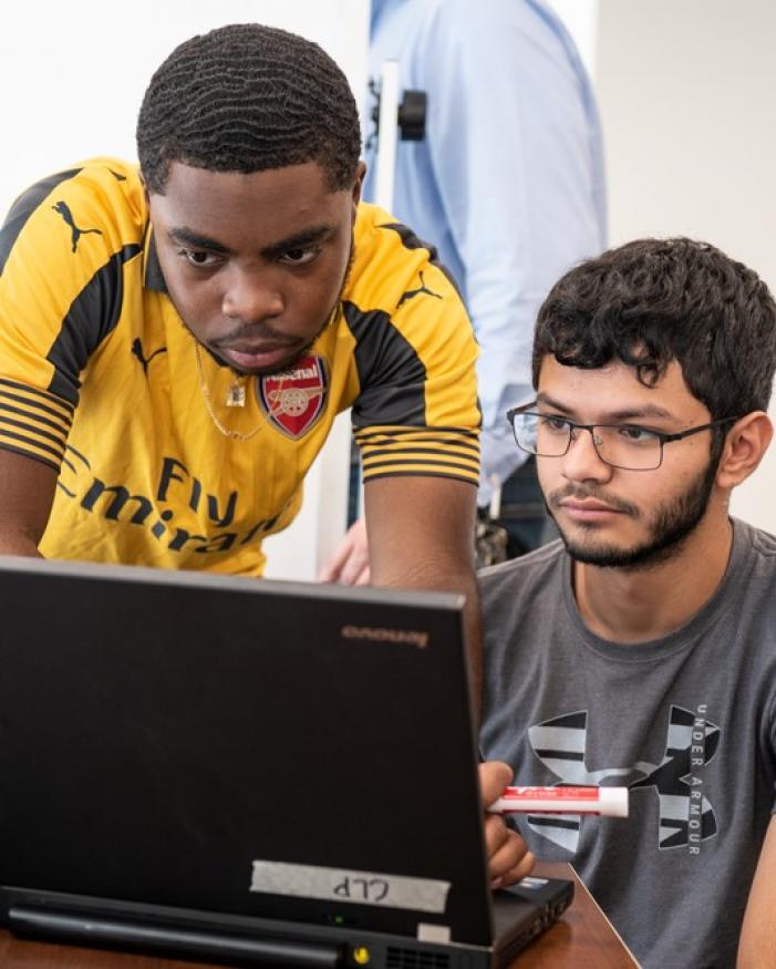 Students looking at a computer