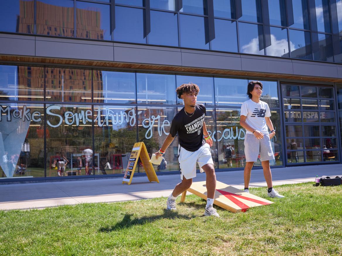 students playing corn hole