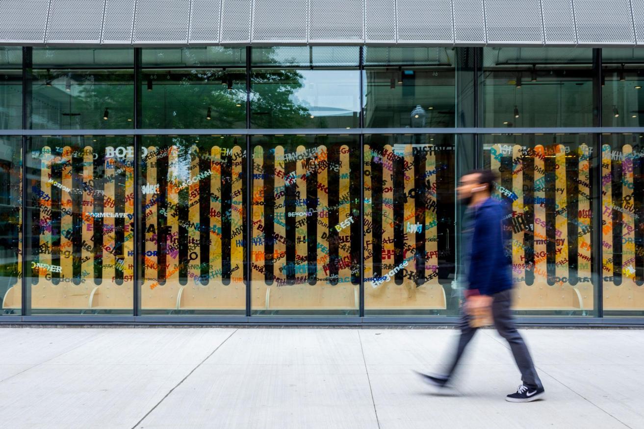 A student walks by the CEIS building in a blur