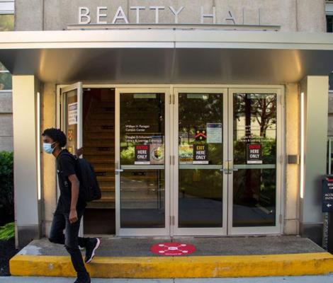 masked student in front of beatty hall