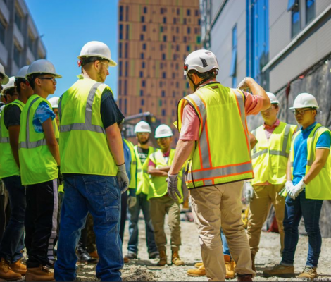 group of workers wearing construction hats and vests