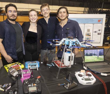 students standing with a robotic drone