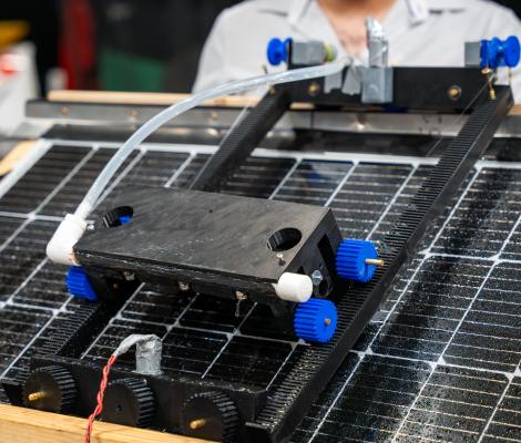 up close picture of a robotic item on top of a solar panel