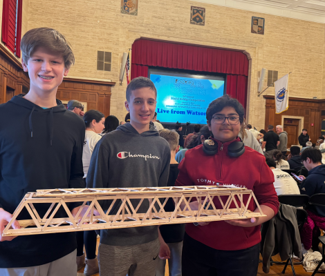 kids holding up a model bridge