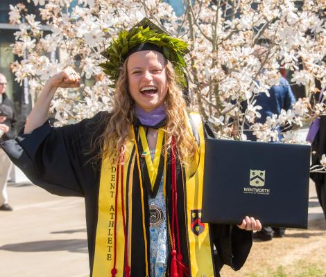 a joyful woman in a graduation robe