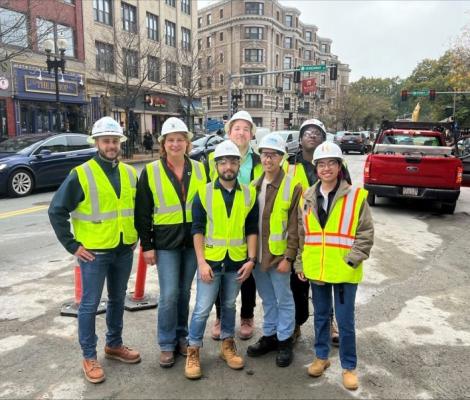 a group of people in the city wearing hard hats