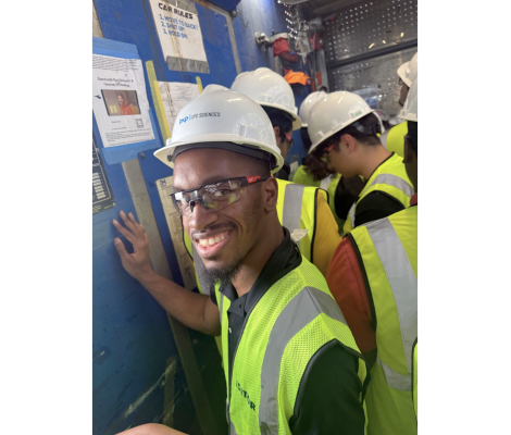 people in hard hats on a company tour