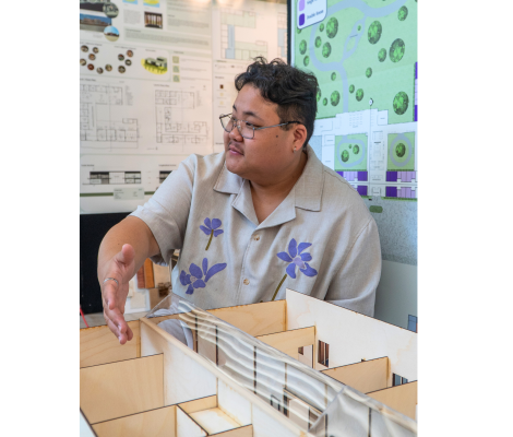 a student presents a model of a memory care facility