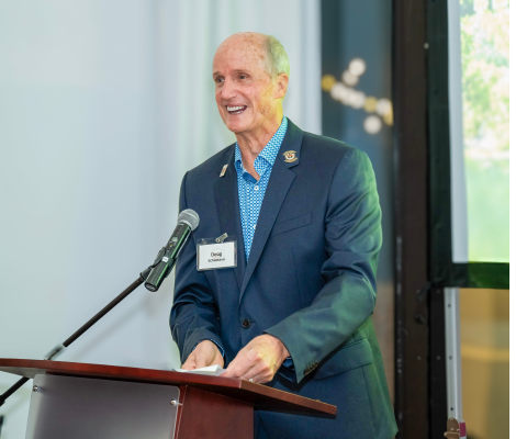 a man smiles at a podium