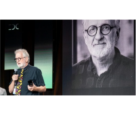 a man speaks on stage at an awards event