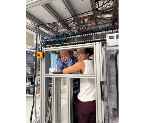 two women in front of a machine