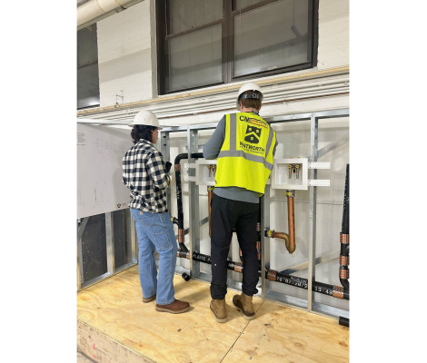 people in hard hats working in a plumbing related lab