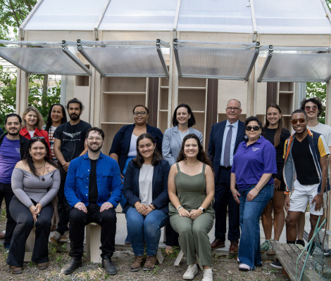 large group of people posing in a garden together