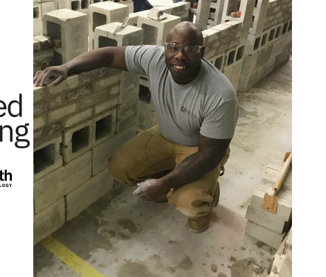 a man squats near concrete