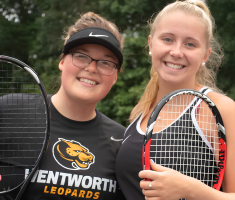 two women holding tennis rackets and wearing clothing that reads "wentworth leopards"
