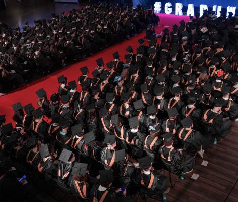 rows of students wearing graduation caps