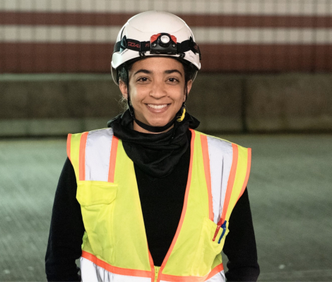 a woman wearing a hard hat and vest