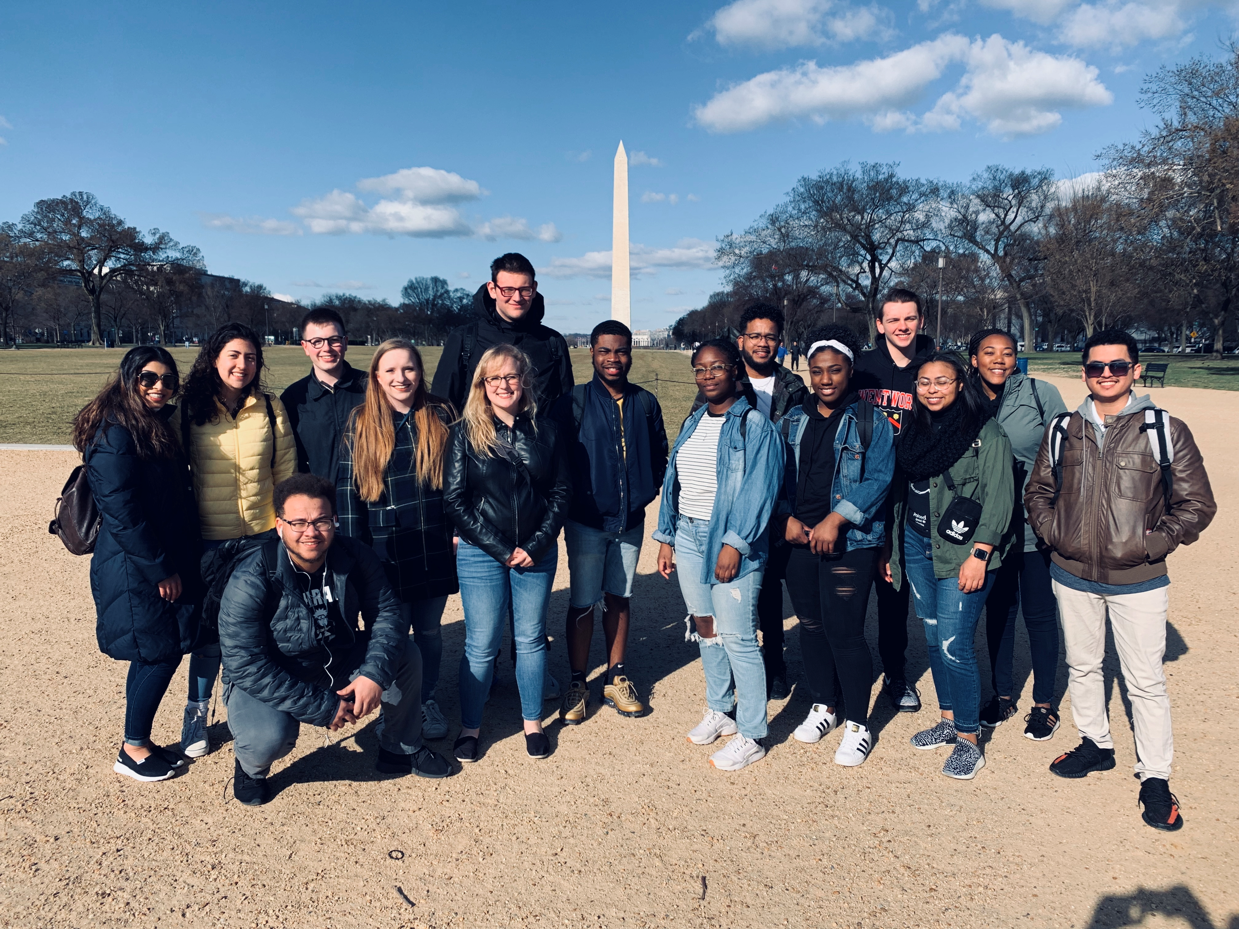 group of students outside in front of a momument