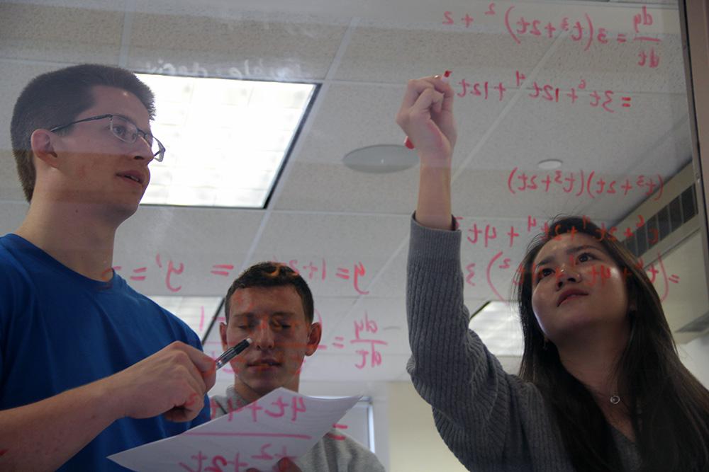 Students working on an equation.
