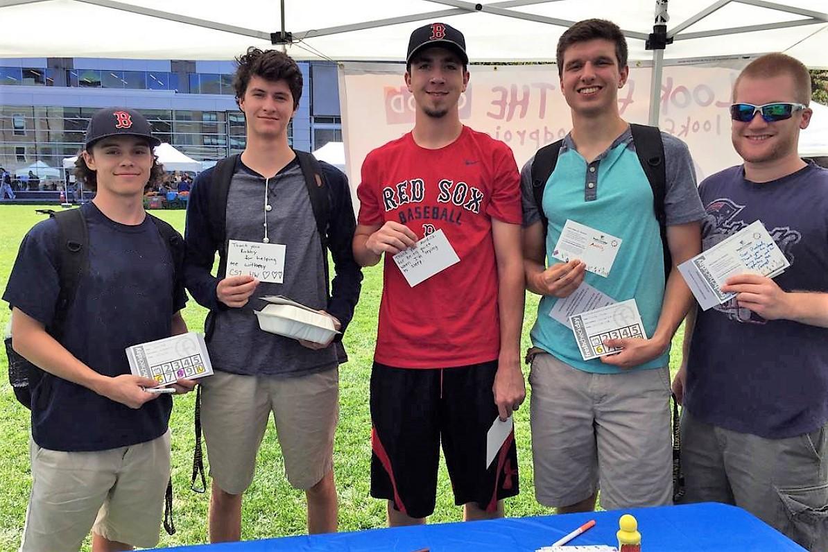 group of students holding up pieces of paper