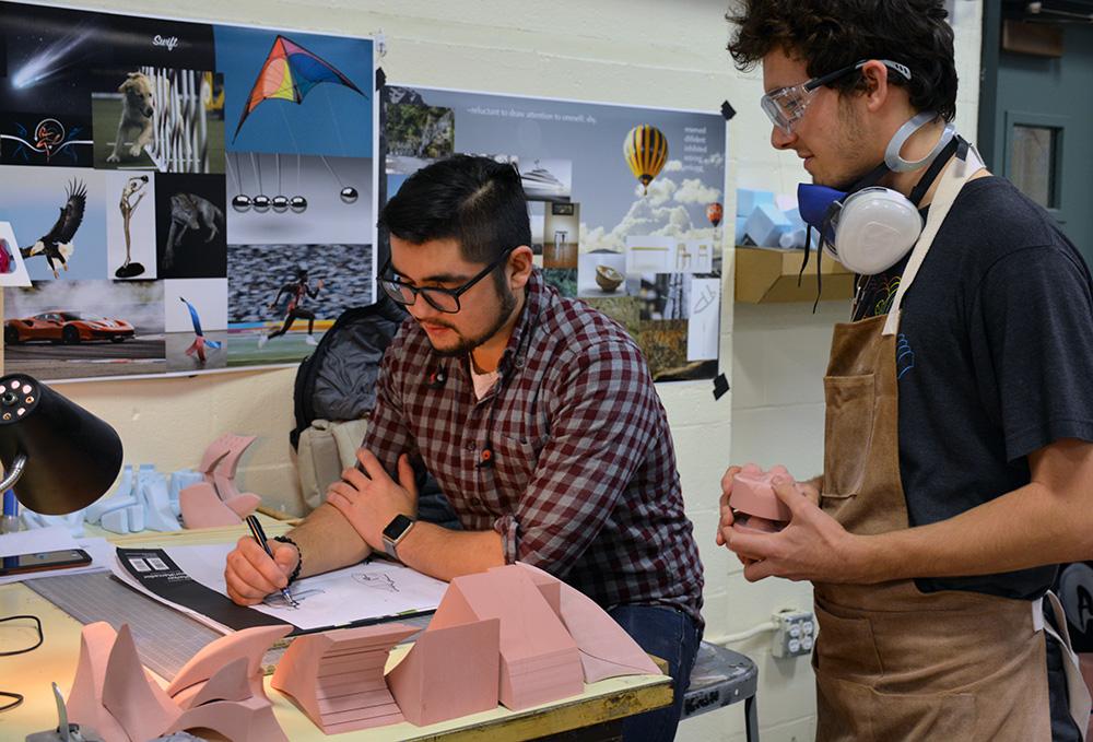 Two students collaborate on an industrial design project.