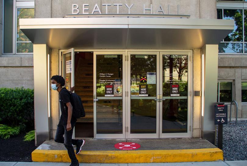 masked student in front of beatty hall