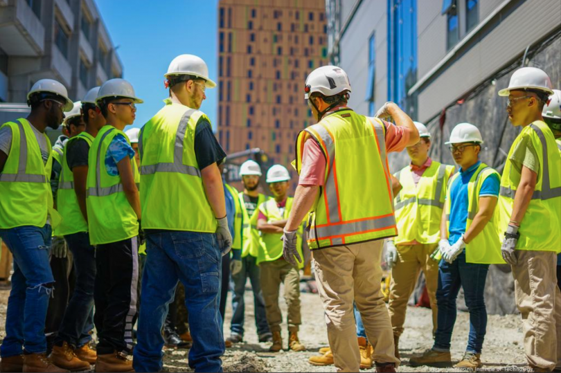 group of workers wearing construction hats and vests