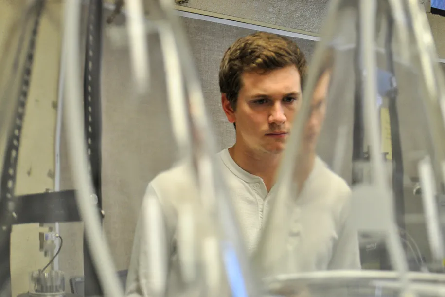 A student examines a piece of equipment