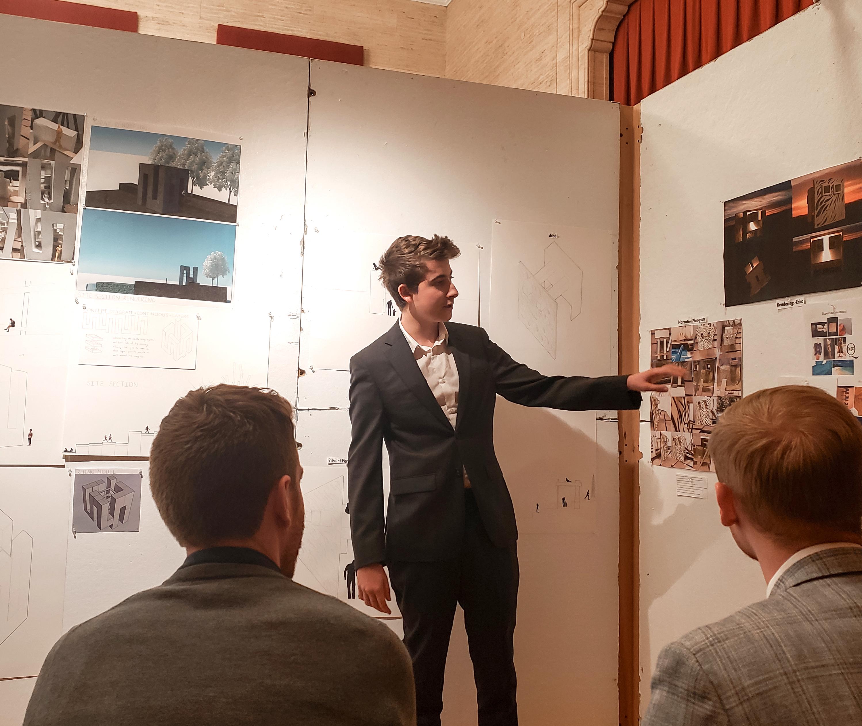 man presenting architectural work to audience