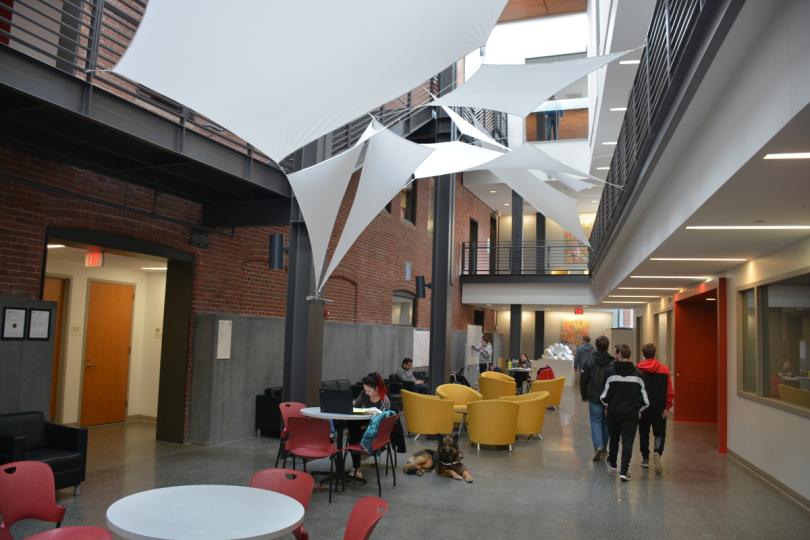 Students study or walk through the Ira Allen Building