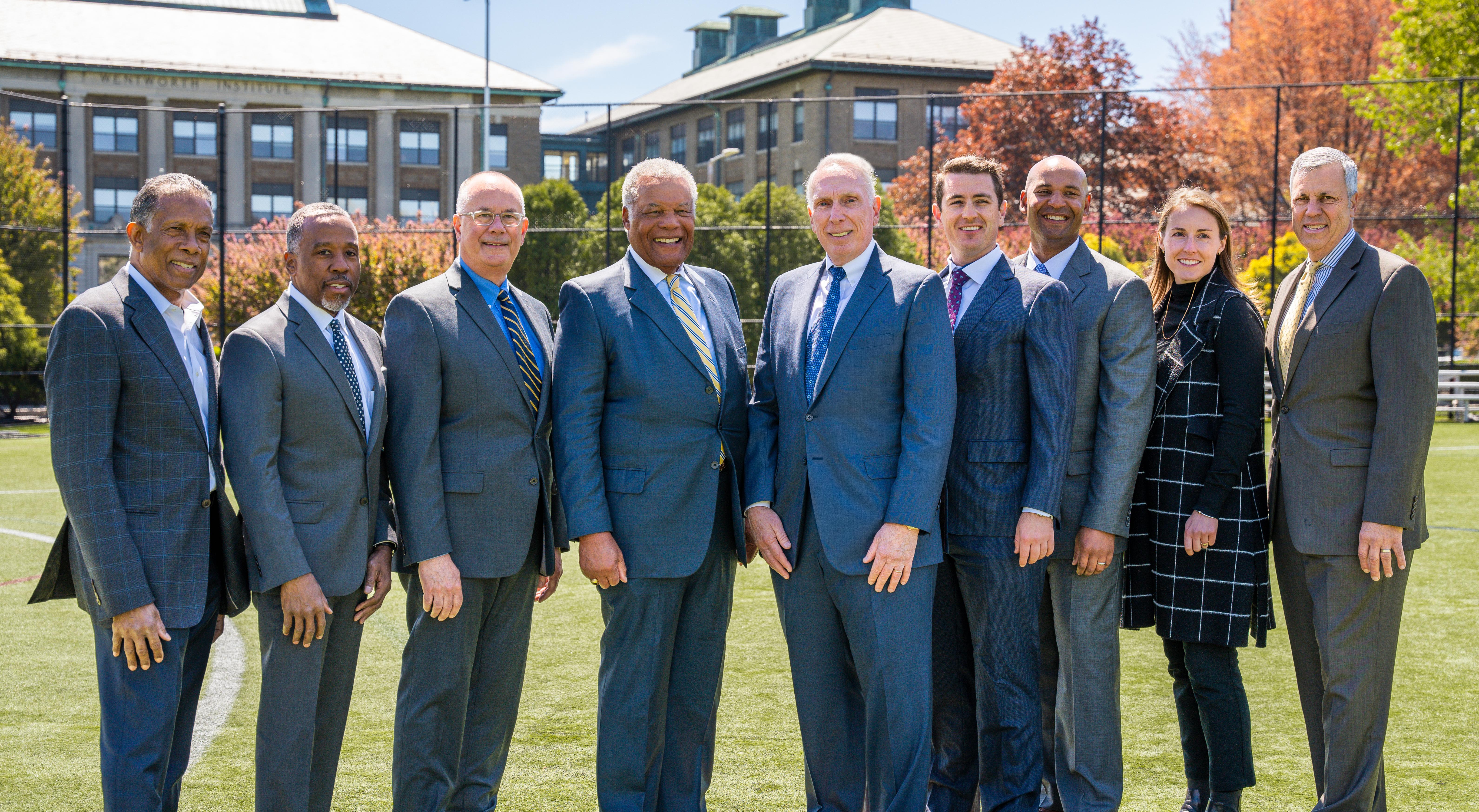 group of people posed on an athletic field