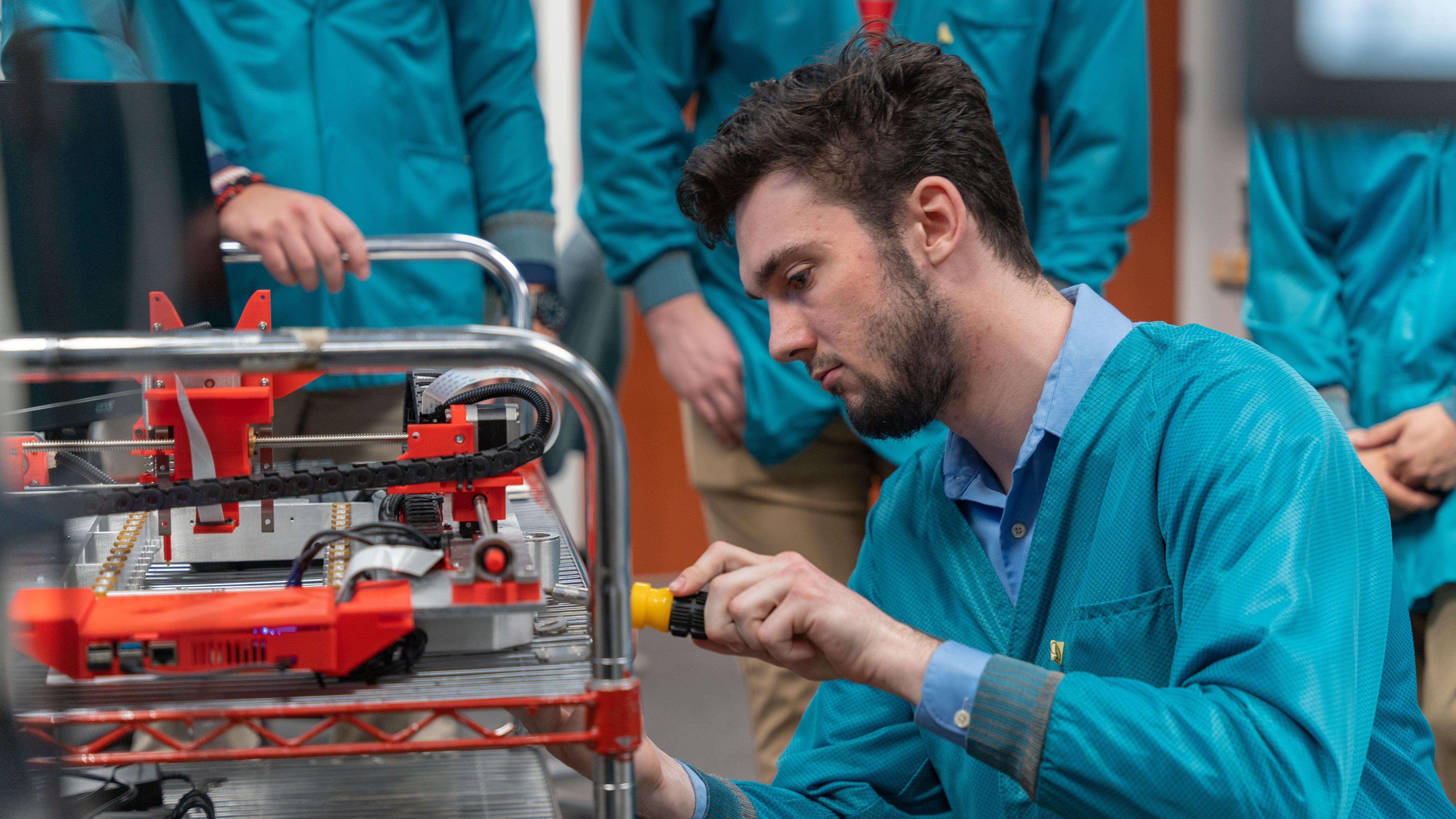 person in a lab working on a computer chip