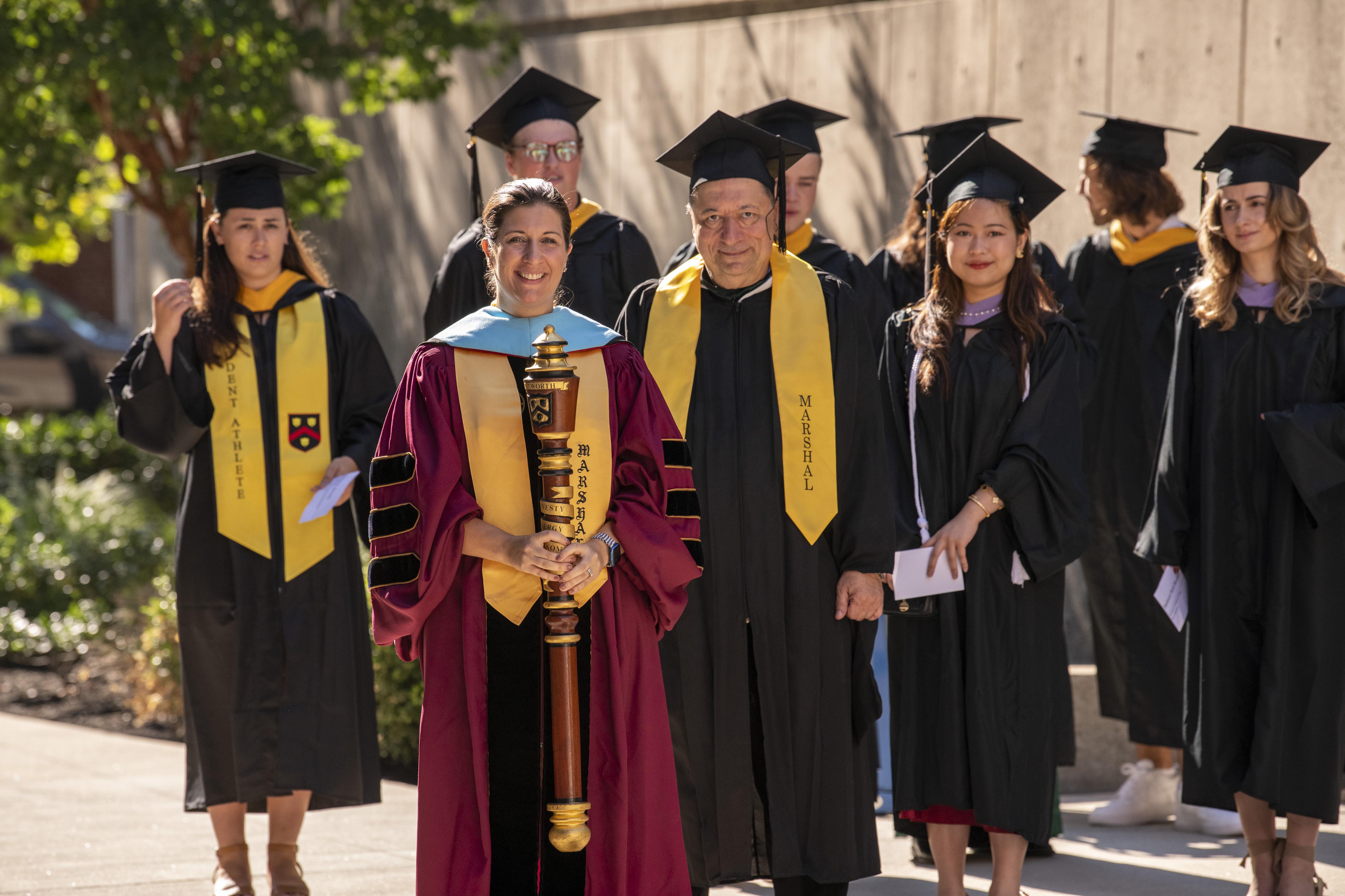 people walking in graduation robes