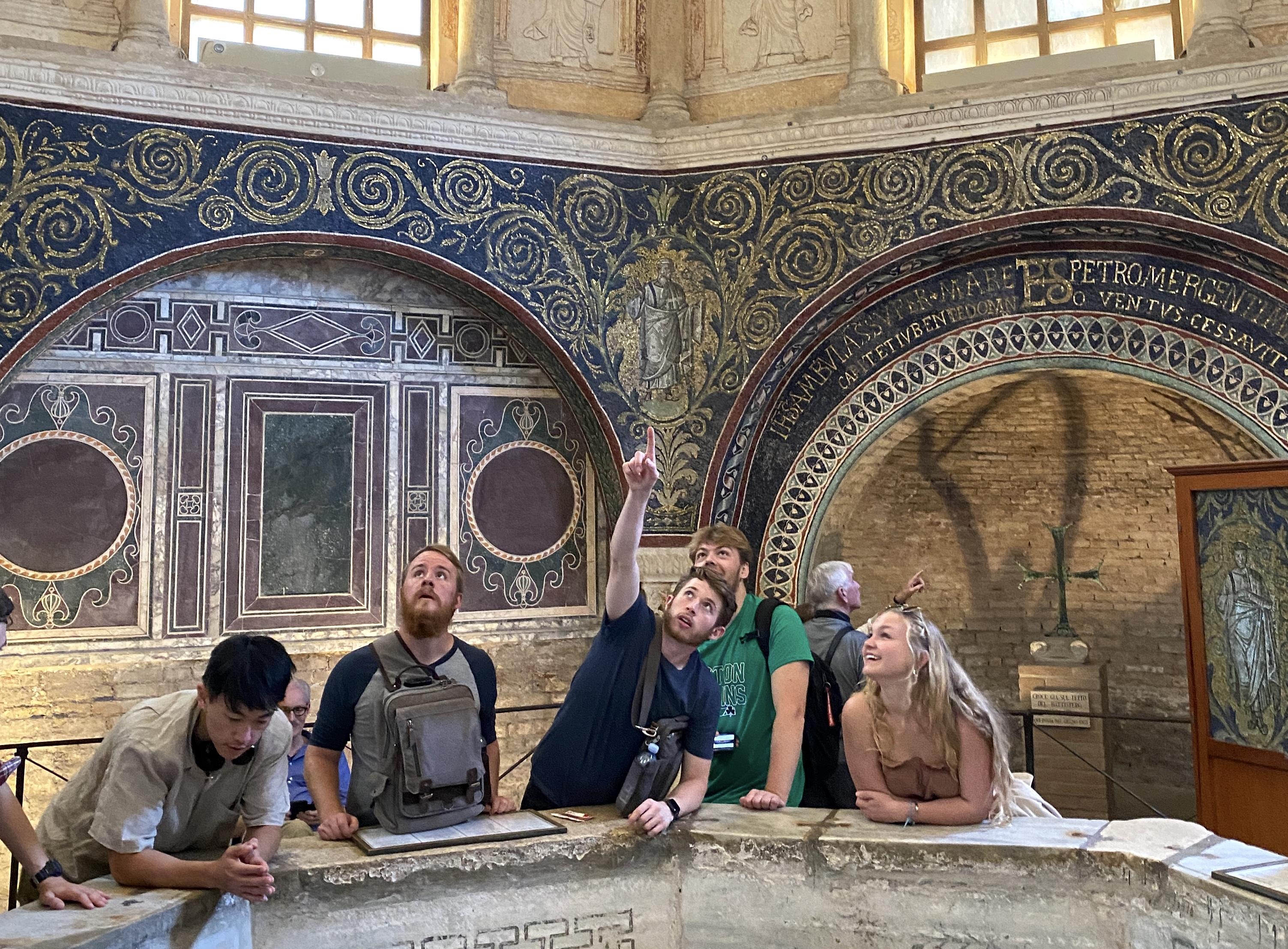 students in a historic building point to various items