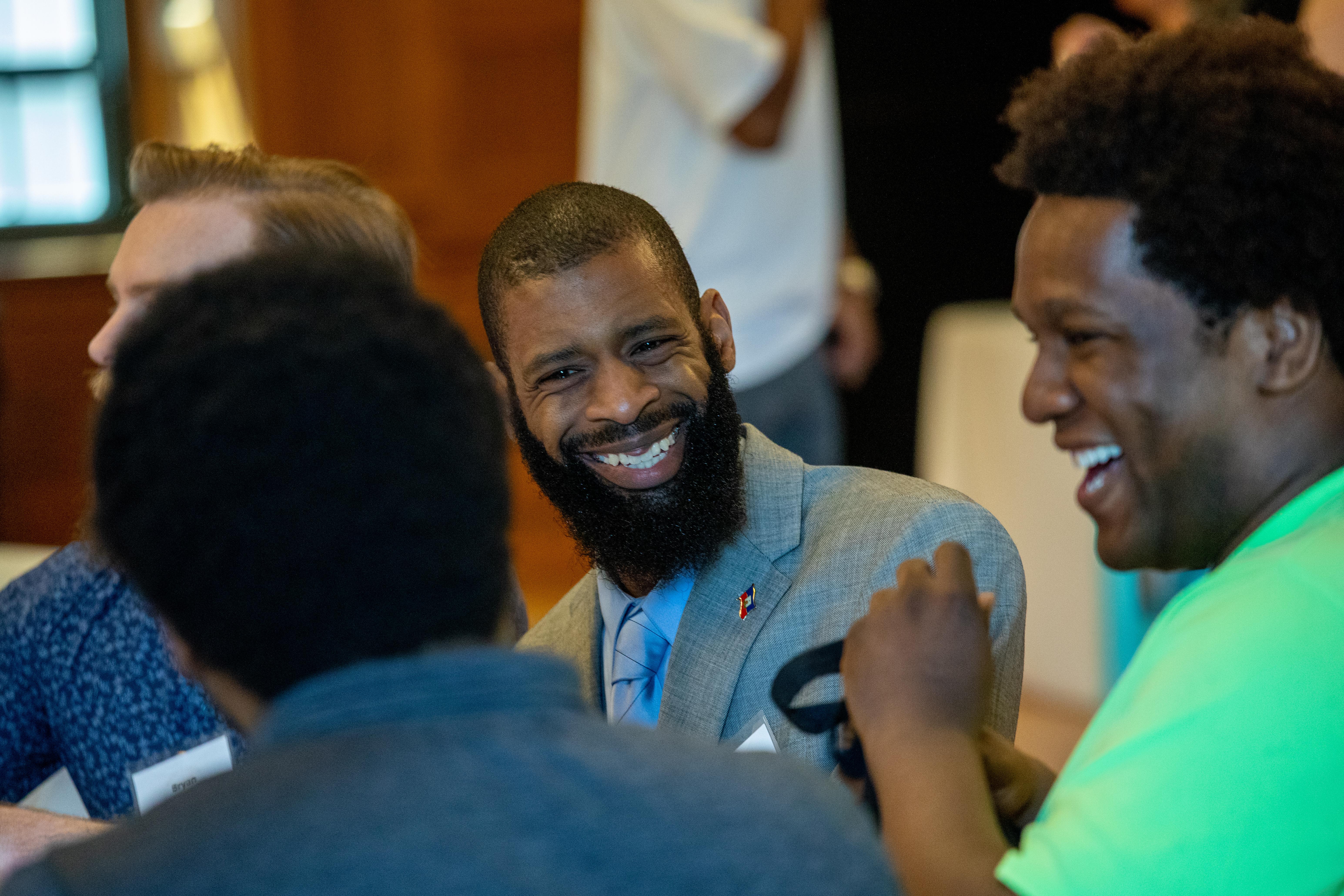 two men share a laugh during a lunch event