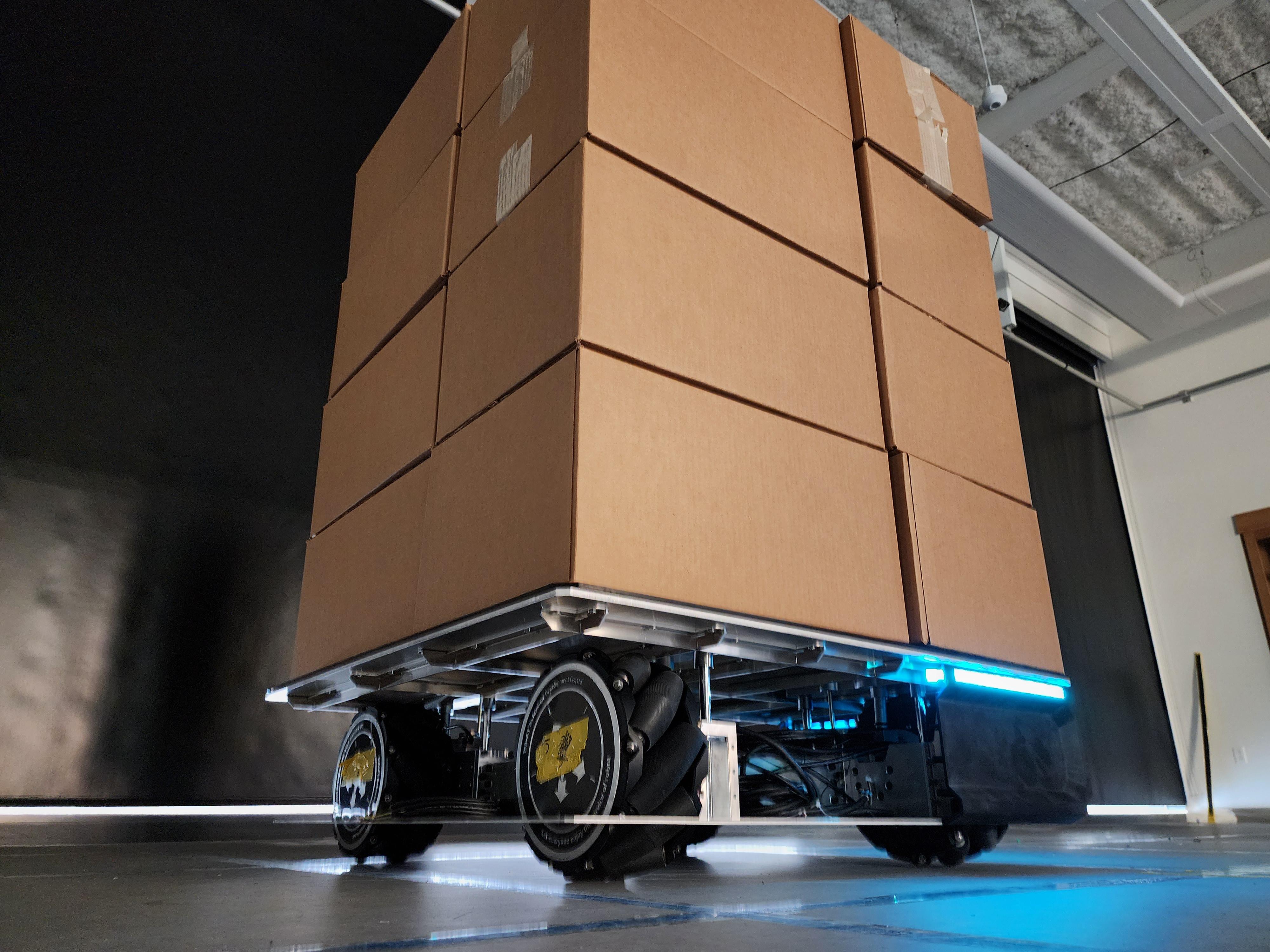 a roboticized pallet carries cardboard boxes