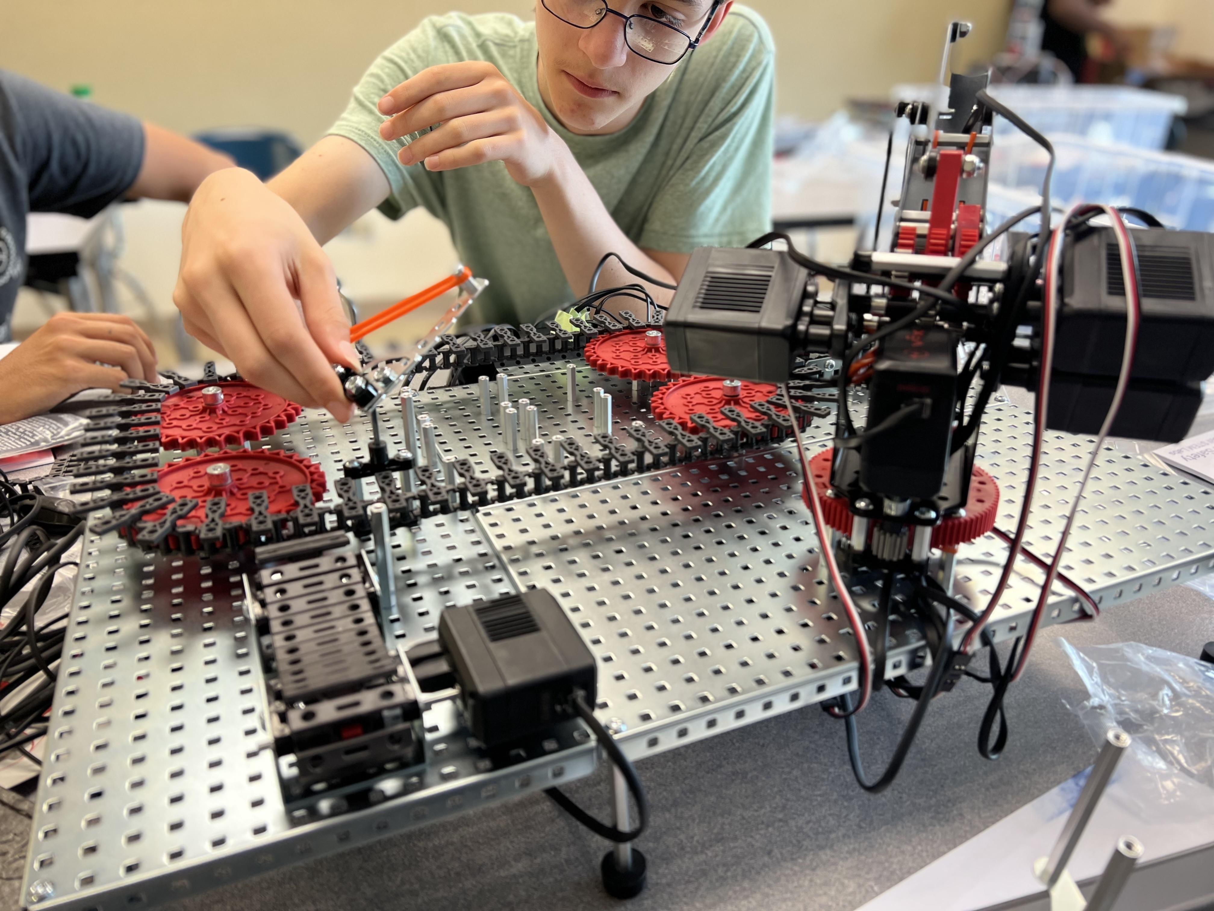 student working on a robot