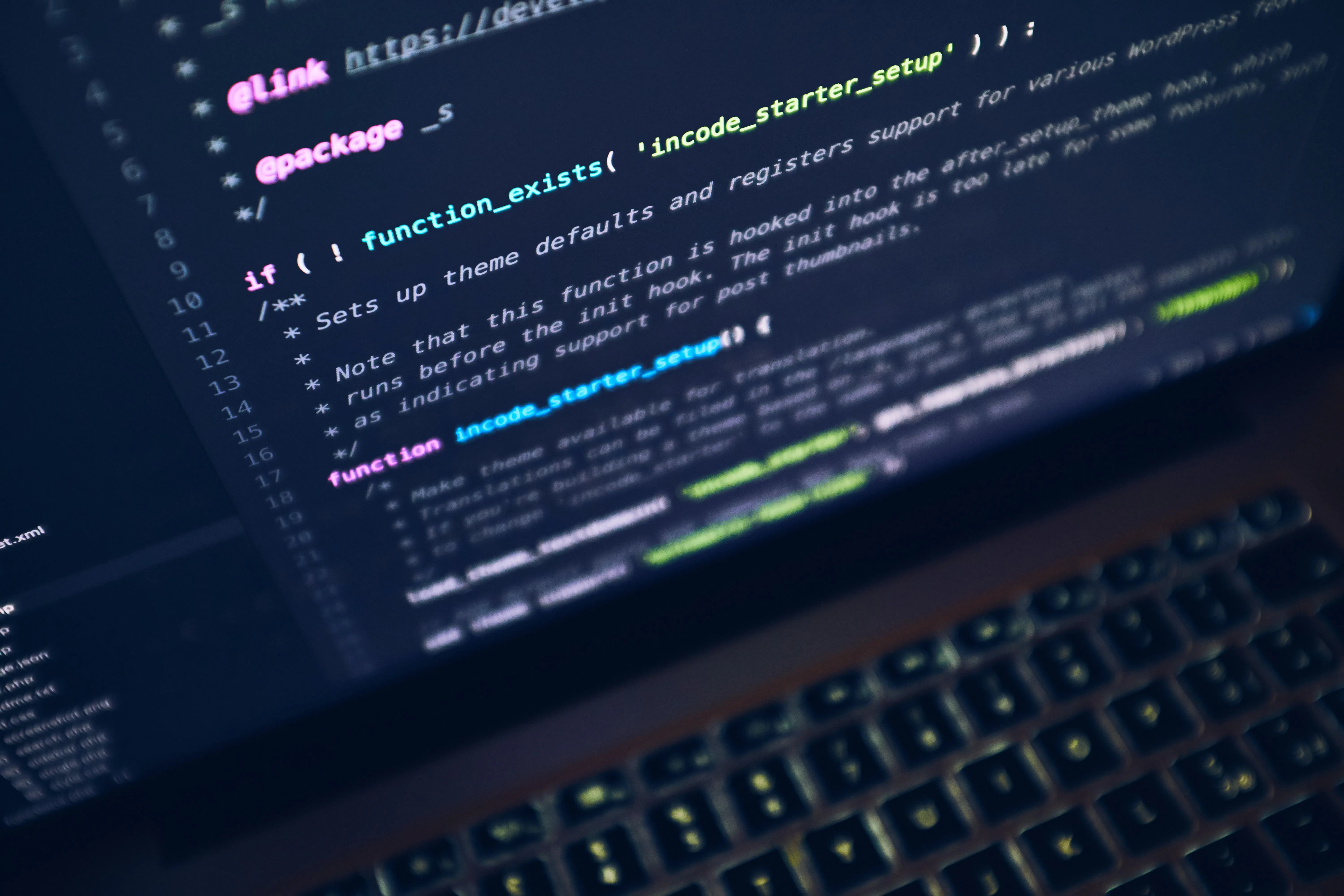 Close up of computer screen coding language with pink, blue and yellow text.