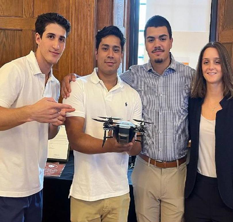 students holding up a drone prototype