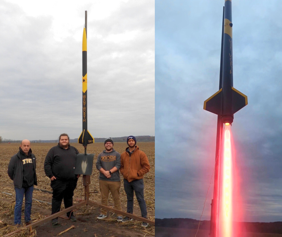 group of people stand with a rocket they built